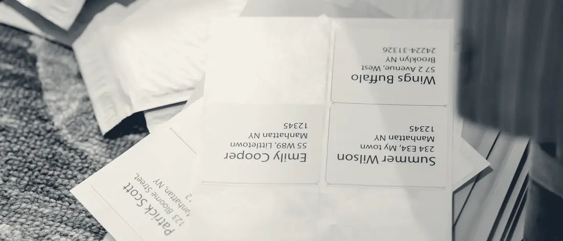 A pile of printed address labels on padded mailers, ready to ship
