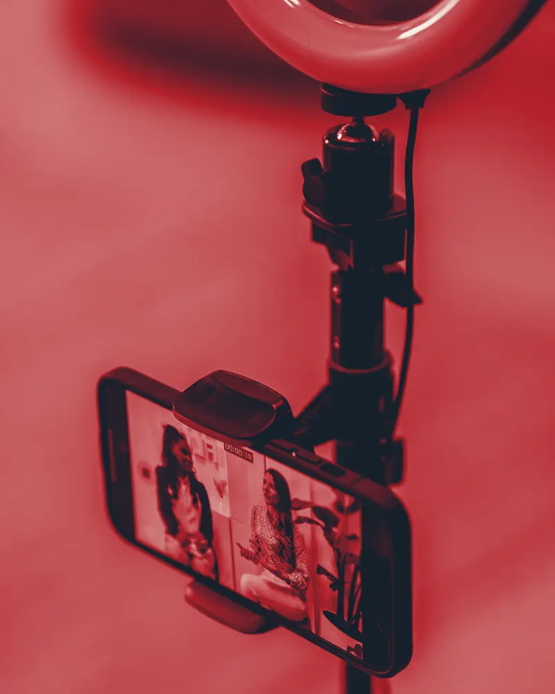 A phone clipped to a ring-light stand, set up for a live selling stream